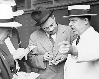 Huey Long speaks with reporters