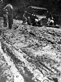 car stuck in the mud on a typical Louisiana road before Huey Long
